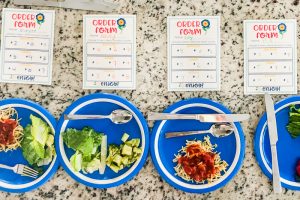 Looking for an out of the box family night activity for Spring? This Spring Mystery Dinner Family Night Activity is a favorite. Your kids will love getting a silly menu and a mixed up dinner surprise. Step by step instructions + FREE Printables so you can easily create lots of laughter and a special memory with your family at home.